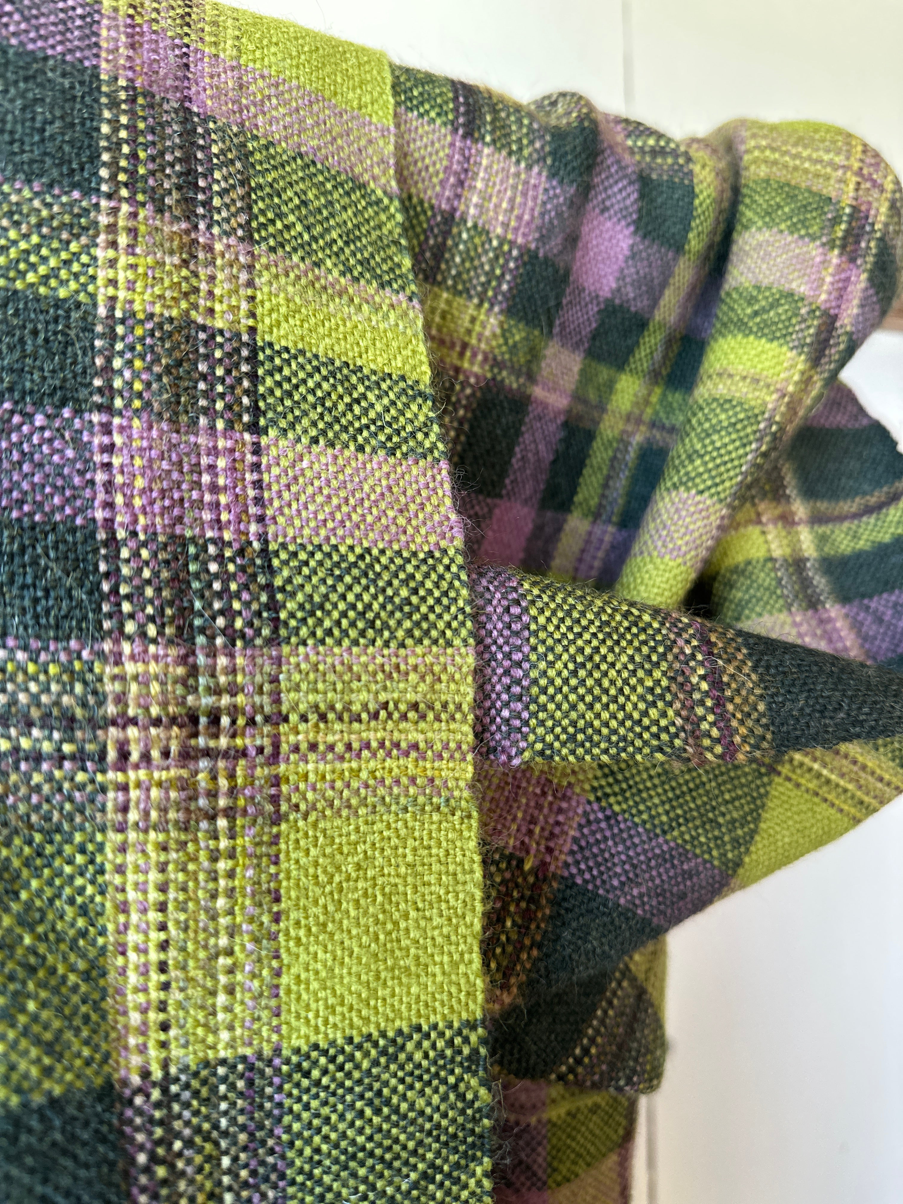 Close-up of green and purple plaid scarf