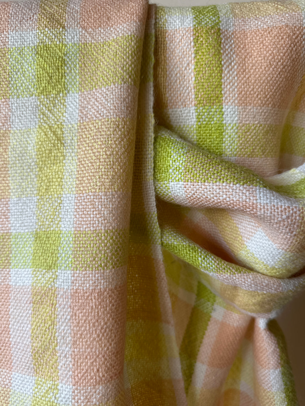 Close-up of checkered scarf with green and pink colours