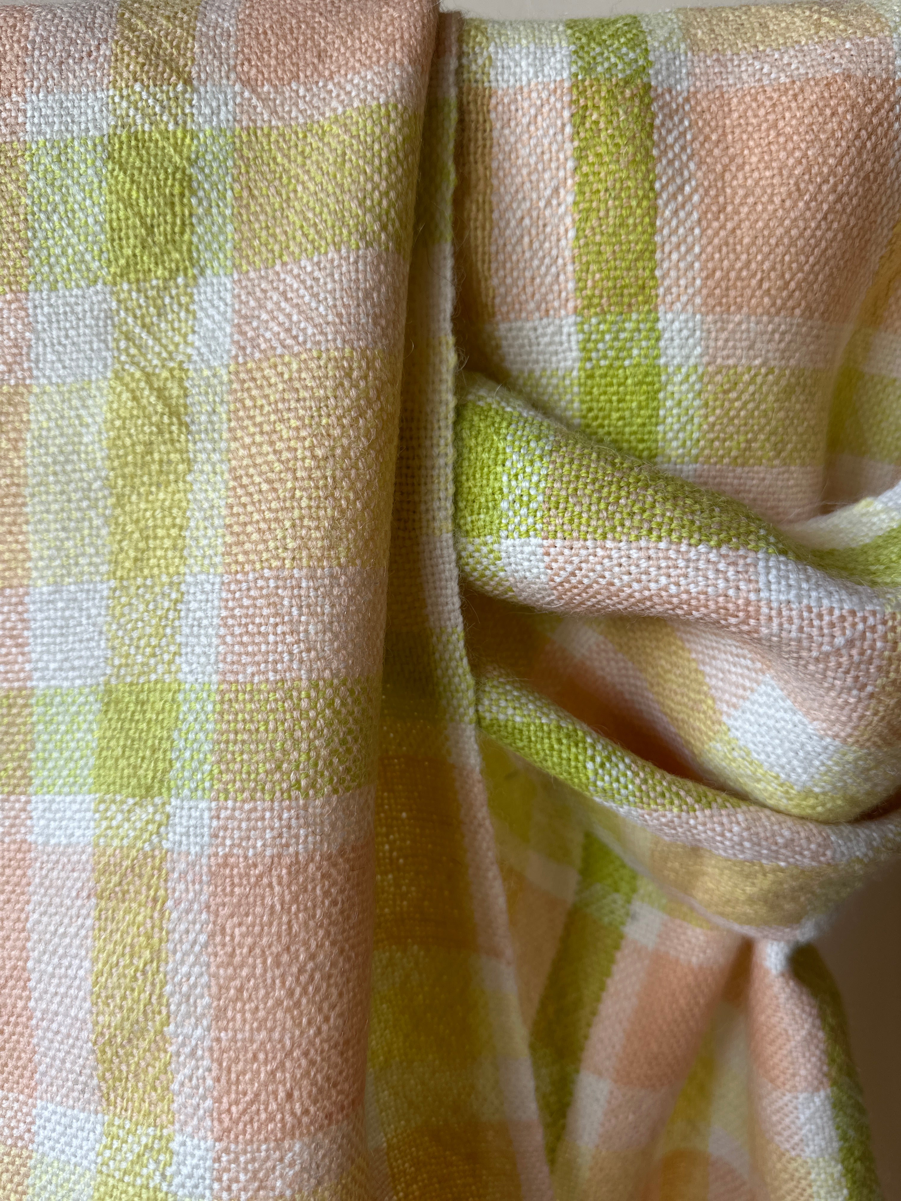 Close-up of checkered scarf with green and pink colours