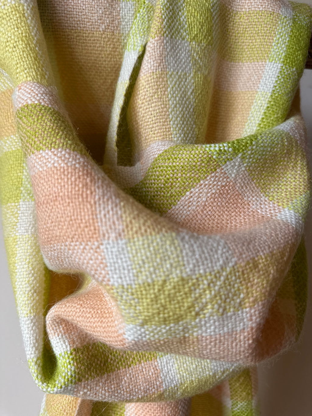 Close-up of checkered fabric with green and beige pattern